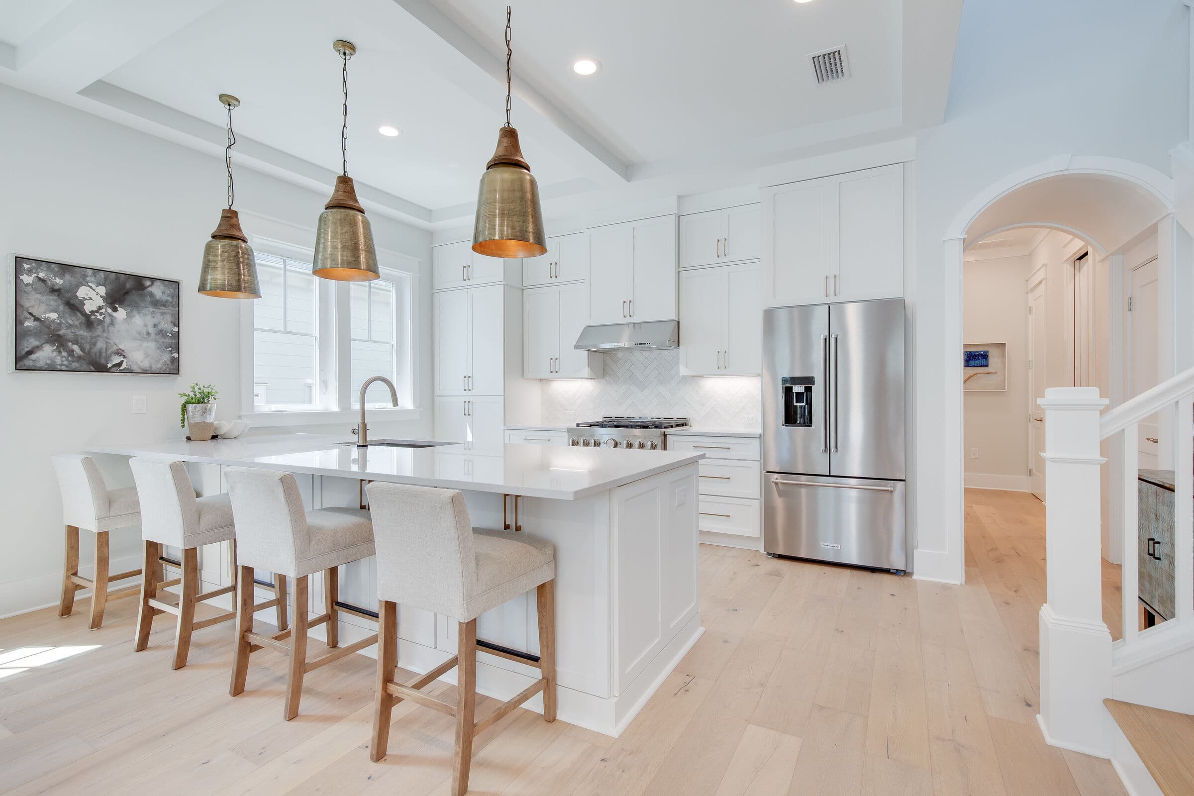 Kitchen island with brass pendant lights